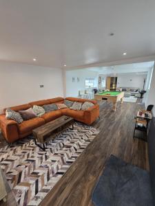 a living room with couches and a pool table at 5 Bed Cottage Free Parking in Stainforth