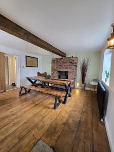 a living room with a table and a fireplace at 5 Bed Cottage Free Parking in Stainforth