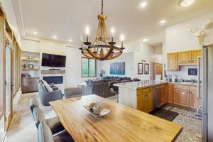 a kitchen with a wooden table and a chandelier at Sun Vail 34D in Vail