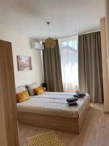 a bedroom with a bed and a large window at Barceló Apartment Velingrad in Velingrad +56 photos