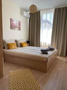 ein Schlafzimmer mit einem großen Bett vor einem Fenster in der Unterkunft Barceló Apartment Velingrad in Welingrad