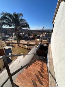 un escalier menant à un bâtiment avec un palmier dans l'établissement Lo De ADRI, à Villa Carlos Paz