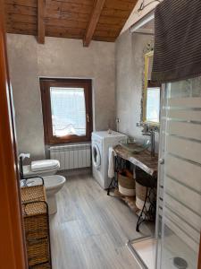 a bathroom with a toilet sink and a washing machine at Black and White in Locate Bergamasco +20 photos