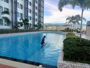 a person in the water in a swimming pool at Arc Tower Condominiums by Rhen in Cebu City