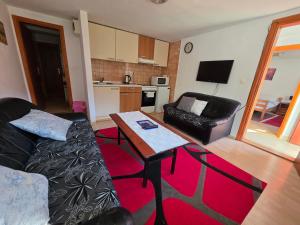 a living room with a couch and a table at Apartment near center in Sarajevo