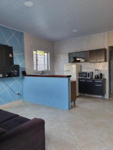 a kitchen with a white counter in a room at Beach house in Peruíbe in Peruíbe