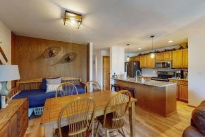 a kitchen and living room with a table and chairs at Marina Place 137 in Dillon