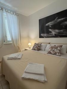 a bedroom with a large bed with a painting on the wall at Onepta Retreat in Reggio di Calabria