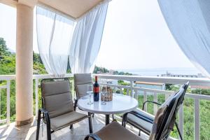 a balcony with a table and chairs and the ocean at Apartments Seaview in Tučepi
