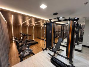 a gym with several treadmills and exercise bikes at Flats New York Meia Praia Itapema in Itapema