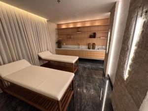 a hospital room with two tables and a tub at Flats New York in Itapema +25 photos