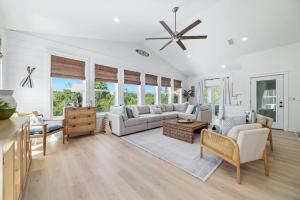 a living room with white furniture and windows at The Avery House in Pensacola +51 photos