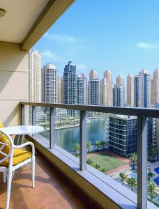 a balcony with a table and a view of a city at Luxury 1 Bedroom Marina View, Sleeps 6, 1 Min to Metro in Dubai