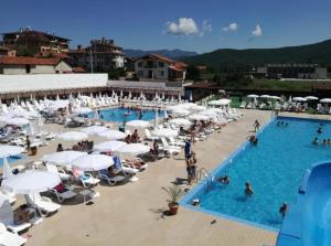 an overhead view of a swimming pool with white umbrellas at Barceló Apartment Velingrad in Velingrad