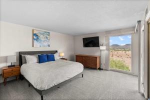 a bedroom with a bed and a large window at Cozy Condo - Stay for 9 in St. George