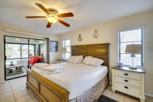 a bedroom with a bed and a ceiling fan at Canal-Front Gem with Lanai and Dock in Cape Coral in Cape Coral Hospital Heliport +22 photos
