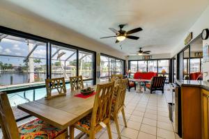 a dining room with a table and chairs at Canal-Front Gem with Lanai and Dock in Cape Coral in Cape Coral Hospital Heliport