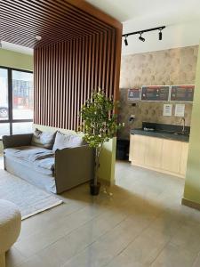 a living room with a couch and a plant in it at Depto 2D moderno y acogedor con ubicación de lujo in San Pedro de la Paz +45 photos