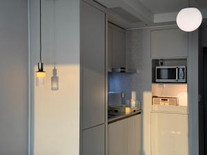 a kitchen with a refrigerator and a microwave at 속초씨에 머물다, sokchosea in xiella in Sokcho +35 photos