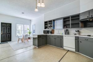 a kitchen with gray cabinets and a dining room at Cozy Lafayette Shared House-Private Bedroom Garden & Free Parking in Lafayette