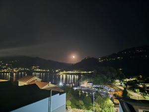 a view of a river at night with the moon at Casa da Praia - Gerês in Bicas