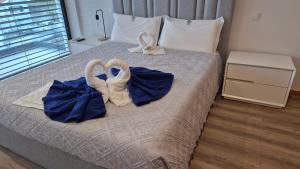 a bed with towels and swans sitting on it at Casa da Praia - Gerês in Bicas
