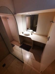 a bathroom with a sink and a mirror at Cape Escape in Cape Town