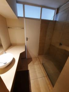 a bathroom with a shower and a sink at Cape Escape in Cape Town +11 photos