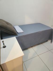 a bed sitting on top of a white table at Morada Aconchegante com 2 quartos and Sofá Cama in Imperatriz +55 photos