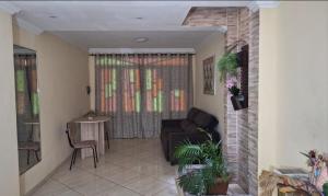 a living room with a couch and a table at Quarto completo com varanda in Belém +4 photos