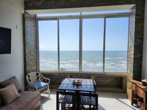 a living room with a view of the ocean at TUCACAS PENTHOUSE VISTA AL MAR y SALIDA A LA PLAYA in Tucacas