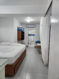 a hospital room with a bed and a bathroom at TUCACAS PENTHOUSE VISTA AL MAR y SALIDA A LA PLAYA in Tucacas +32 photos