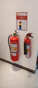 twee rode brandkranen op een plank met een bordje bij Best View Guest Inn Ella in Ella