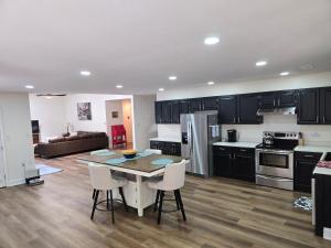 a kitchen and living room with a table and chairs at Spacious & Serene 3 bedrooms in New Bern