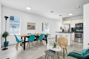 a kitchen and dining room with a table and chairs at Palm Breeze Retreat in Hollywood