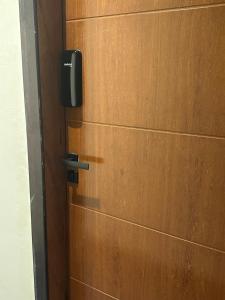 a wooden door with a tv on the wall at Pousada Central Araquari in Araquari