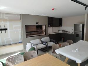 a dining room with tables and chairs and a kitchen at let health flow in Montevideo +23 photos