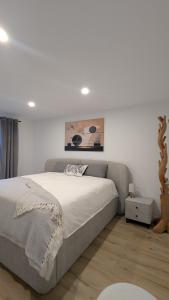a bedroom with a large bed and a painting on the wall at Tauberblick Obere Walkmühle in Rothenburg ob der Tauber
