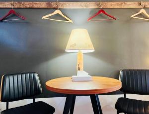 a table with a lamp in a room with chairs at Elk Antler Inn in Thermopolis +67 photos