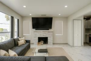 a living room with a couch and a fireplace at The Pacific Nest - 10min from LAX in Hawthorne