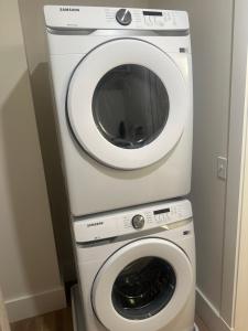 a washing machine and a dryer in a room at High Rise Downtown Apartment in South Bend