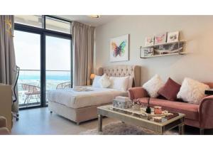 a living room with a bed and a couch at Soho Saadiyat Island Poolside Luxury Retreat - Moments from Louvre Abu Dhabi in Abu Dhabi +31 photos