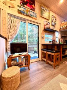 a living room with a large window in a house at Forest Nook in Queens Bay