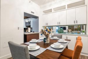 a kitchen and dining room with a table and chairs at Spacious 2 Bedroom Condo in DTLA, Large Private Patio, Pets Welcomed in Los Angeles