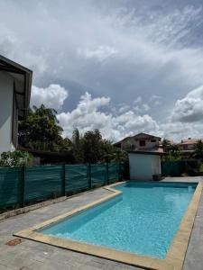 a swimming pool in the backyard of a house at Kaz'Baduel piscine, terrasse, wifi et climatisation in Cayenne