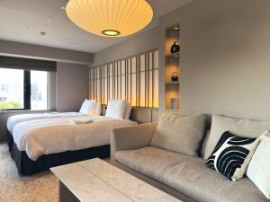 a hotel room with two beds and a couch at Richmond Hotel Asakusa in Tokyo +43 photos