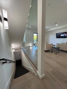 a glass staircase in a living room with a couch at 906 Brand new townhome sleeps 10 in Redwood City