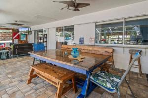a wooden table with a blue vase on top at Pirates Den in Apollo Beach