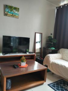 a living room with a large flat screen tv at 3 BRooms 3 Baths Cozy Condo, One Manchester Place in Lapu Lapu City