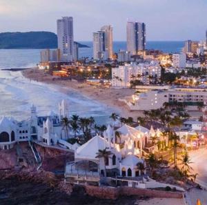 a view of a city with a beach and buildings at Casa al Mare in Mazatlán